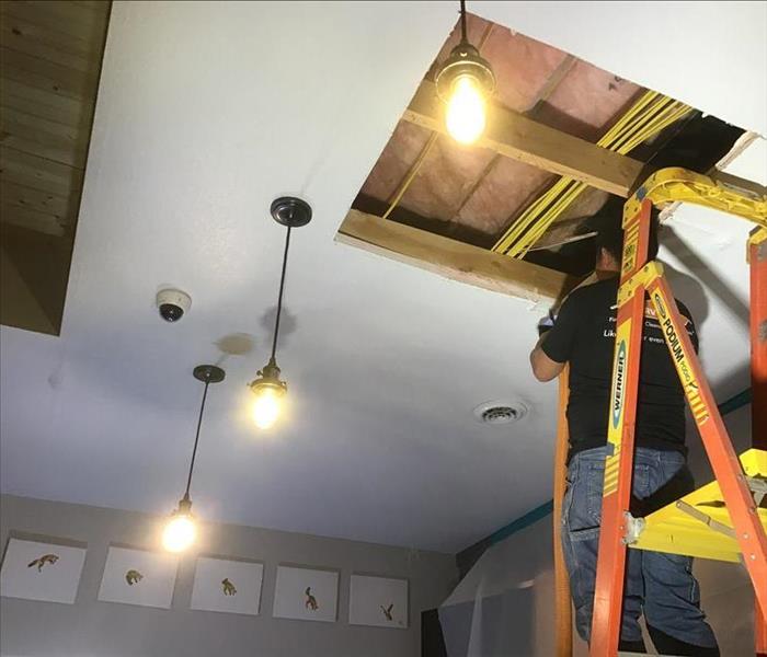 repairing the water damage in the ceiling
