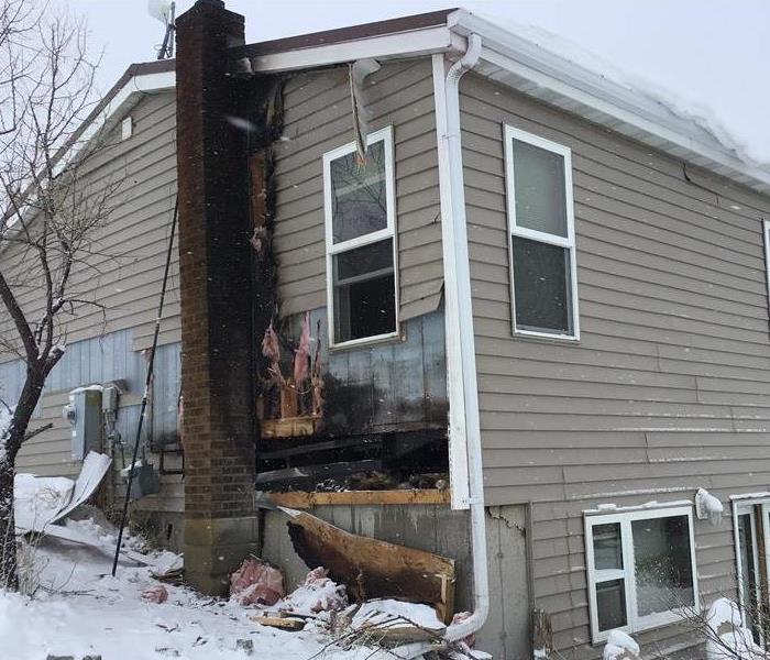a side of a home with prominent fire damage
