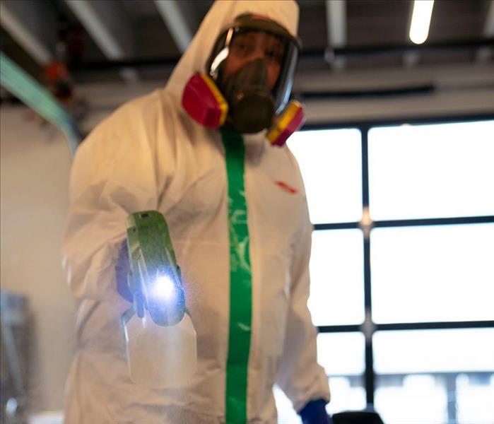 a guy spraying disinfectant